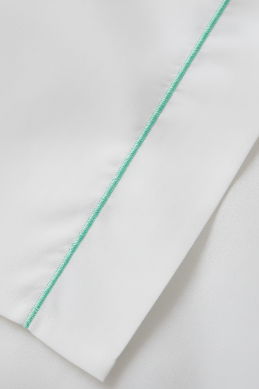 White fabric with toned-down straight green stitch